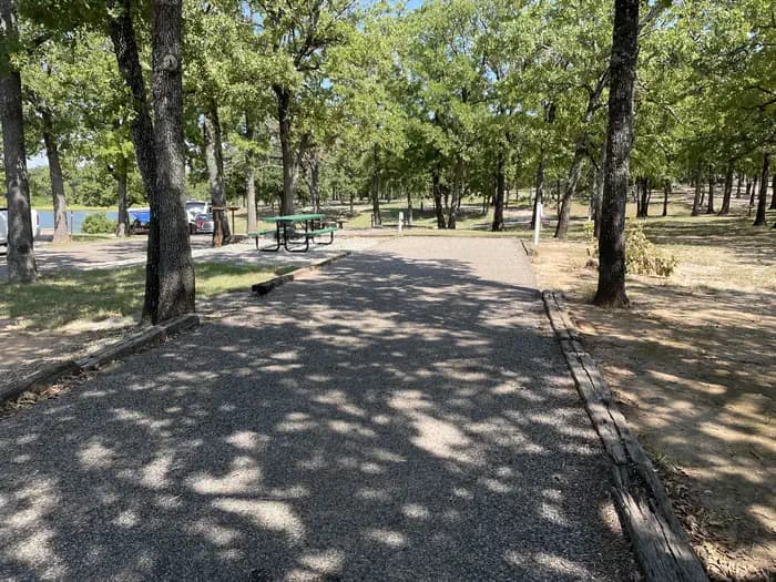A photo of Site 13 of Loop JCRE at JOHNSON CREEK with Picnic Table, Electricity Hookup, Fire Pit, Shade, Water Hookup