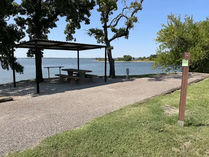A photo of Site 38 of Loop JCRE at JOHNSON CREEK with Picnic Table, Electricity Hookup, Fire Pit, Shade, Waterfront, Water Hookup