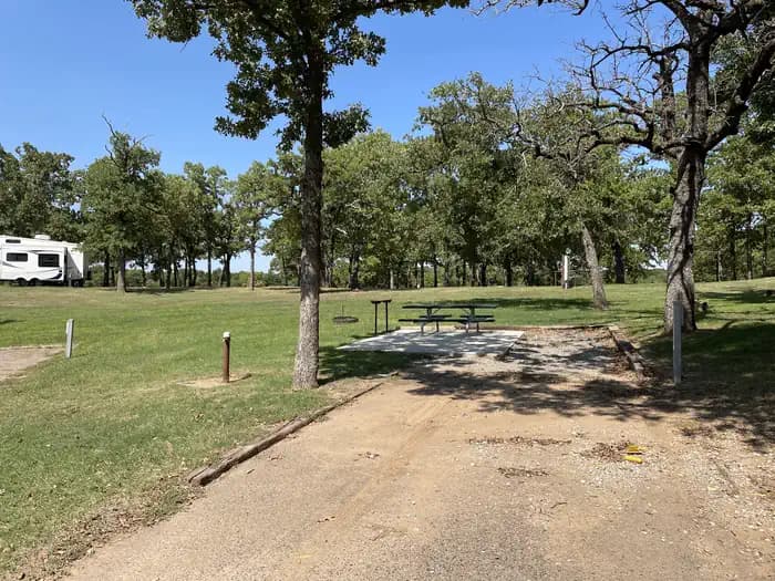 A photo of Site 20 of Loop JCRE at JOHNSON CREEK with Picnic Table, Electricity Hookup, Fire Pit, Shade, Water Hookup