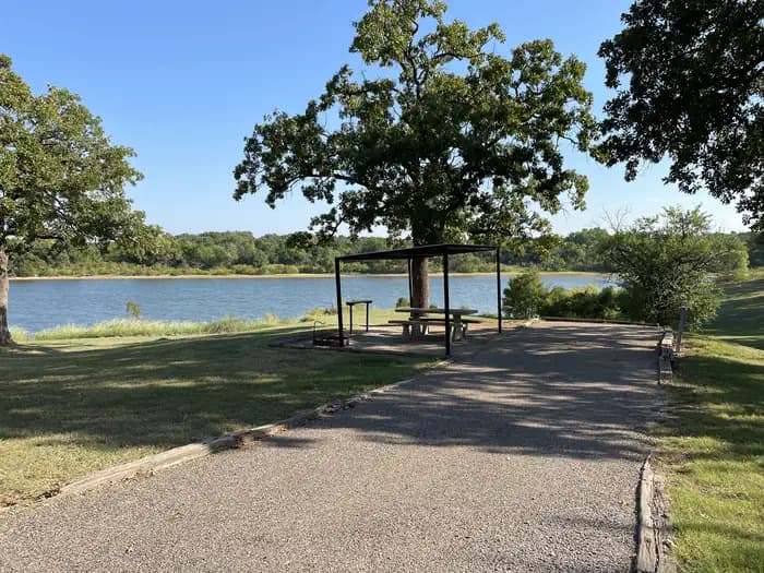 A photo of Site 09 of Loop JCRE at JOHNSON CREEK with Picnic Table, Electricity Hookup, Fire Pit, Shade, Waterfront, Water Hookup