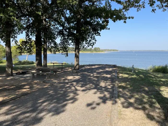 A photo of Site 39 of Loop JCRE at JOHNSON CREEK with Picnic Table, Electricity Hookup, Fire Pit, Shade, Waterfront, Water Hookup