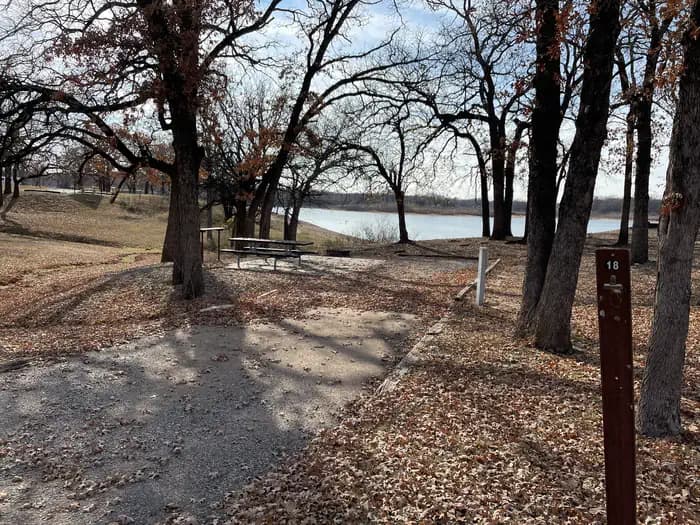 A photo of Site 18 of Loop JCRE at JOHNSON CREEK with Picnic Table, Electricity Hookup, Fire Pit, Shade, Water Hookup