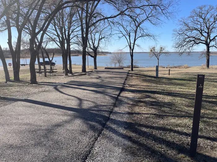 A photo of Site 41 of Loop JCRE at JOHNSON CREEK with Picnic Table, Electricity Hookup, Fire Pit, Shade, Waterfront, Water Hookup